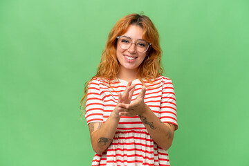 Young caucasian woman isolated on green screen chroma key background applauding after presentation in a conference