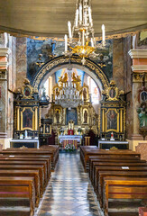 Obraz premium Pilica, Poland - July 25, 2022: Main nave of St. John Baptist parish church, kosciol Sw. Jana Chrzciciela, in historic old town quarter of Pilica in Silesia region of Poland