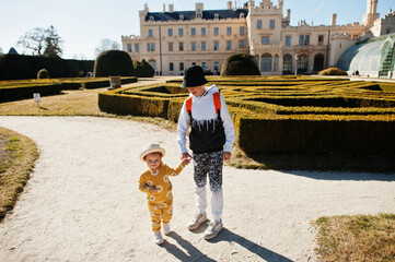 Brother with sister walking at Lednice castle, Czech Republic.