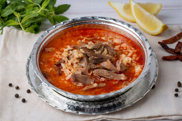 Turkish Soup Beyran with Lamb Meat, Rice, Chopped Garlic and Vinegar Sauce. Traditional Organic Food. Traditional soup of Gaziantep, Turkey. (Turkish name; Beyran corbasi)