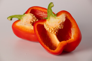 Red bell pepper in section close-up on a white background