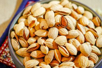 Close up a pile of almonds on the indoor table