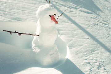 Snowman in the snow during winter