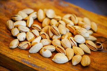 Close up a pile of almonds on the indoor table