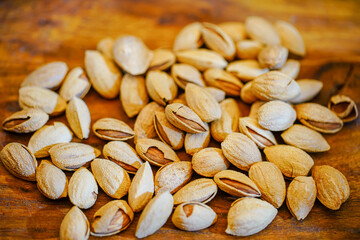 Close up a pile of almonds on the indoor table