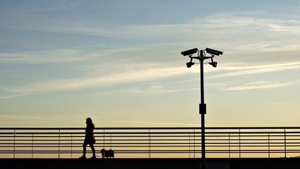 person walking under the surveillance of a camera