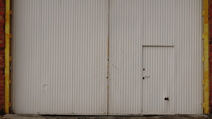 large metal door of industrial building as background