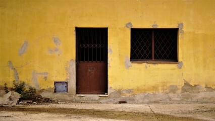 facade of rustic and abandoned building from sidewalk