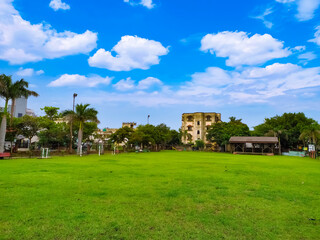 beautiful scenery of park, blue sky white clouds and greenery in a park