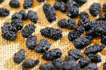 There are many naturally dried black wolfberries on the table