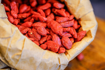 There are many naturally dried red wolfberries on the table