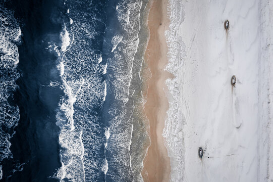 Boats On Winter Snowy Beach, Baltic Sea. Nature In Winter