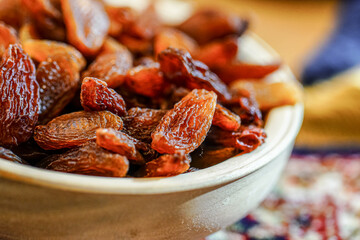 There are many naturally dried red raisins on the table