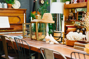 large wooden dining table with retro decor items. collecting antiques.