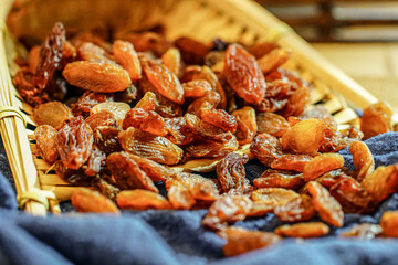 There are many naturally dried red raisins on the table