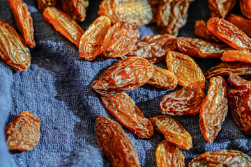 There are many naturally dried red raisins on the table