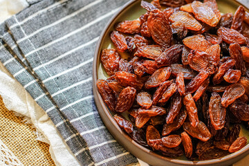 There are many naturally dried red raisins on the table
