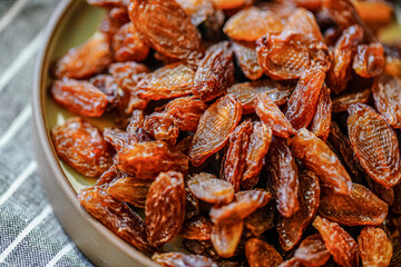 There are many naturally dried red raisins on the table
