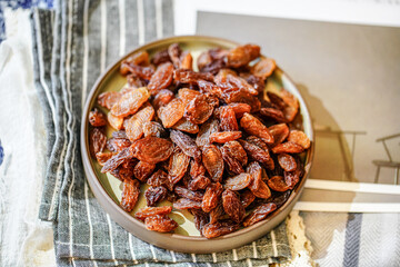 There are many naturally dried red raisins on the table