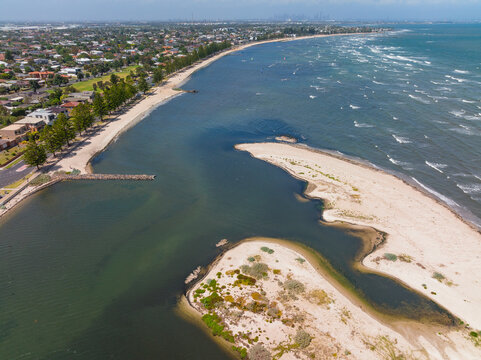 Aerial view of an unusually shaped sand bar running along a bayside beach