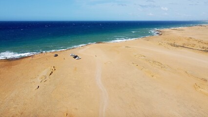 Colombia , Guajira  , Cabo de la Vela , Punta Galinas is a remote desert village on Colombia’s northern when the sand of the desert  and the dunes  arrive in the ocean sea- drone aerial view