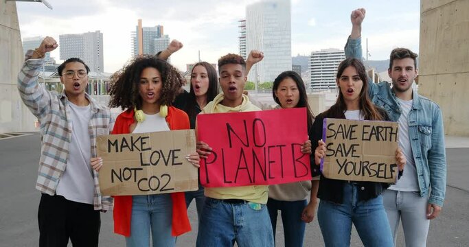 Group of multi-ethnic youth protests with posters in defense of the Earth. Activists protesting against pollution and global warming