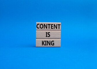 Content is king symbol. Concept words Content is king on wooden blocks. Beautiful blue background. Business and Content is king concept. Copy space.