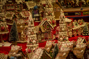 Advent Bazaar Stalls with glass, wooden, ceramic christmas souvenirs in shops. Close up of festive decorations for tree in winter street night market during new year's holiday. Illuminated fair kiosk