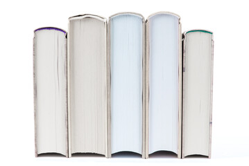 Row of books on white background, book block side, reading and education concept