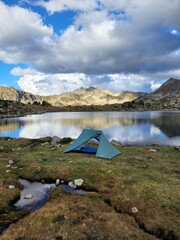 Camping tent in the mountains by a lake
