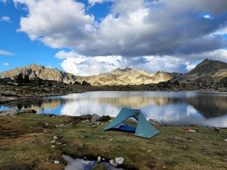 Camping tent in the mountains by a lake
