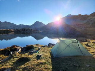 Camping tent in the mountains by a lake