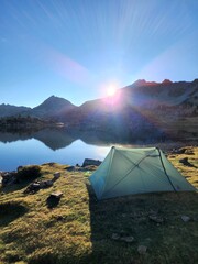 Camping tent in the mountains by a lake