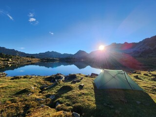 Camping tent in the mountains by a lake