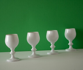 White wine glasses stand cold in the snow and are ready for New Year's drinks at the midnight party