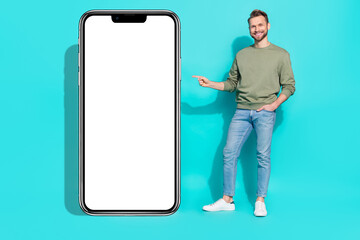 Full body photo of millennial guy indicate promo wear shirt jeans shoes isolated on teal background