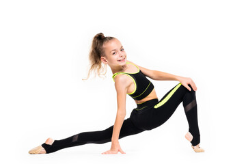 Flexible little girl gymnast in black sports gymnastic suit does acrobatic exercises isolated on a...