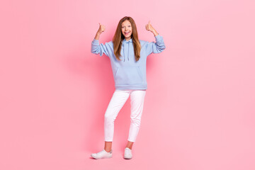 Full size portrait of positive girl two arms fingers demonstrate thumb up approve isolated on pink color background