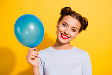 Photo of funny adorable girl dressed white shirt rising blue balloon isolated yellow color background