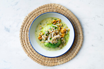 Cockles ceviche with avocado, red onion and puffed corn. Traditional recipe from Peru.