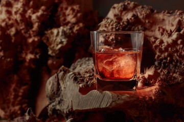 Whiskey with ice on an old dried snag.