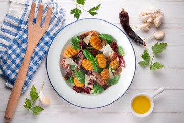 Gnocchi salad with bacon and Italian cheese.