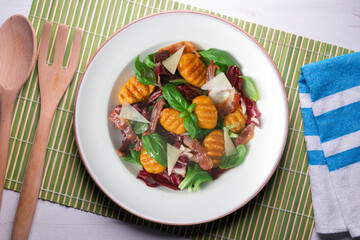 Gnocchi salad with bacon and Italian cheese.