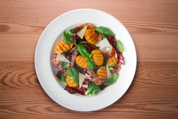 Gnocchi salad with bacon and Italian cheese.