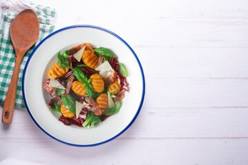 Gnocchi salad with bacon and Italian cheese.
