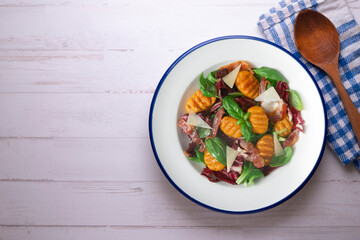 Gnocchi salad with bacon and Italian cheese.