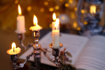 stack of vinyl discs, notes, burning candles in a candlestick, magical objects in a dim room, an atmosphere of magic, the development of imagination, Halloween holiday, cozy musical holiday mood