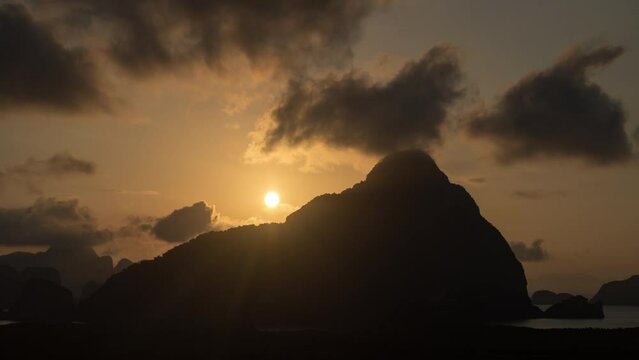 4K beautiful glowing sunset going up behind a SMED NANG-SHE mountain top