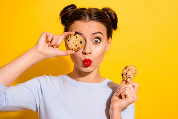 Photo of pretty flirty lady wear long sleeve holding biscuits cover eye pouted lips isolated yellow...