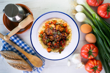 Marinated chicken with vegetables and couscous. Traditional African recipe.